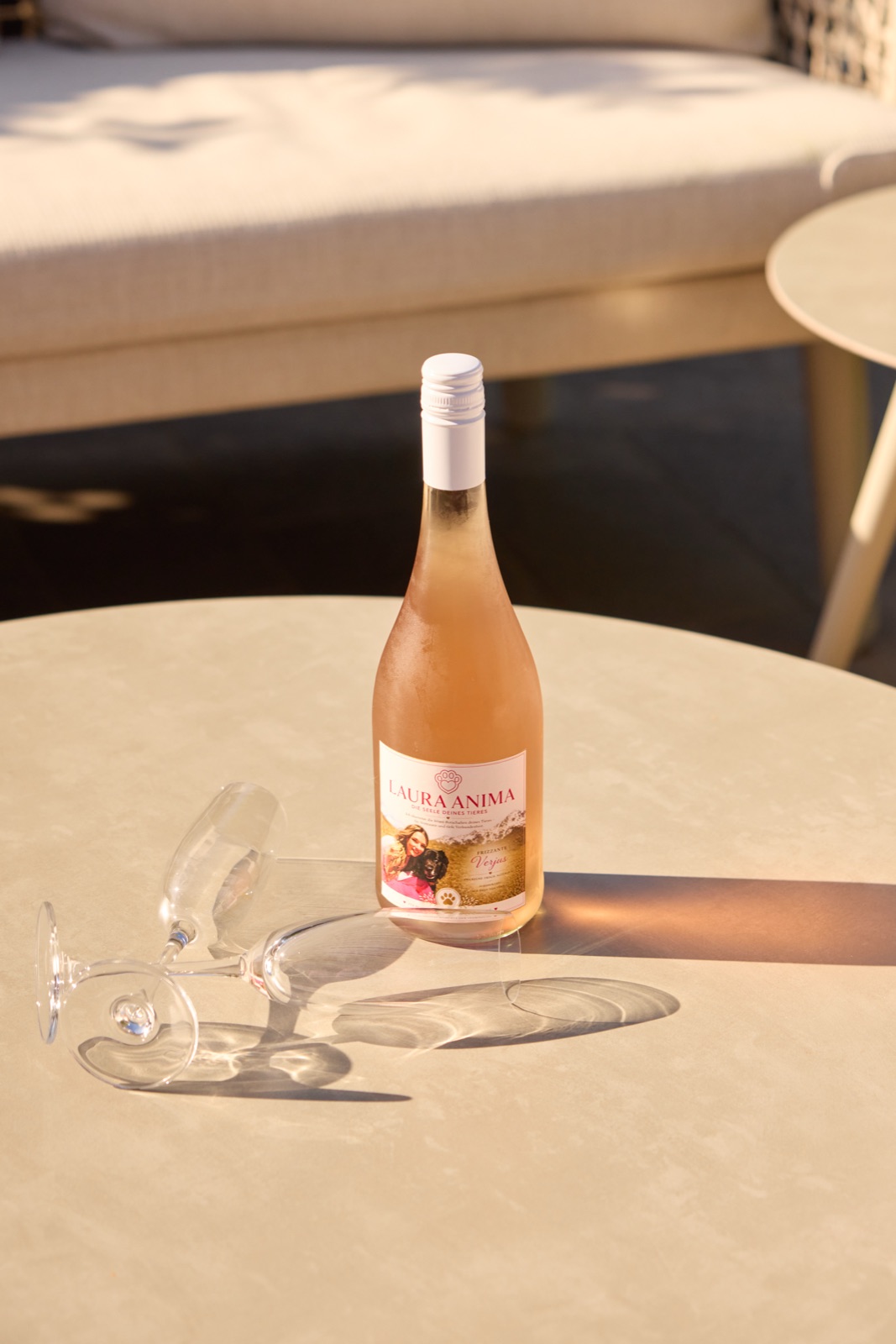 Flasche Frizzante in der Abendsonne auf dem Terrassentisch